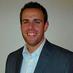 Headshot of SEO expert Brandon Hassler smiling in a suit