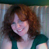 Headshot of SEO expert Julie Joyce with curly red hair