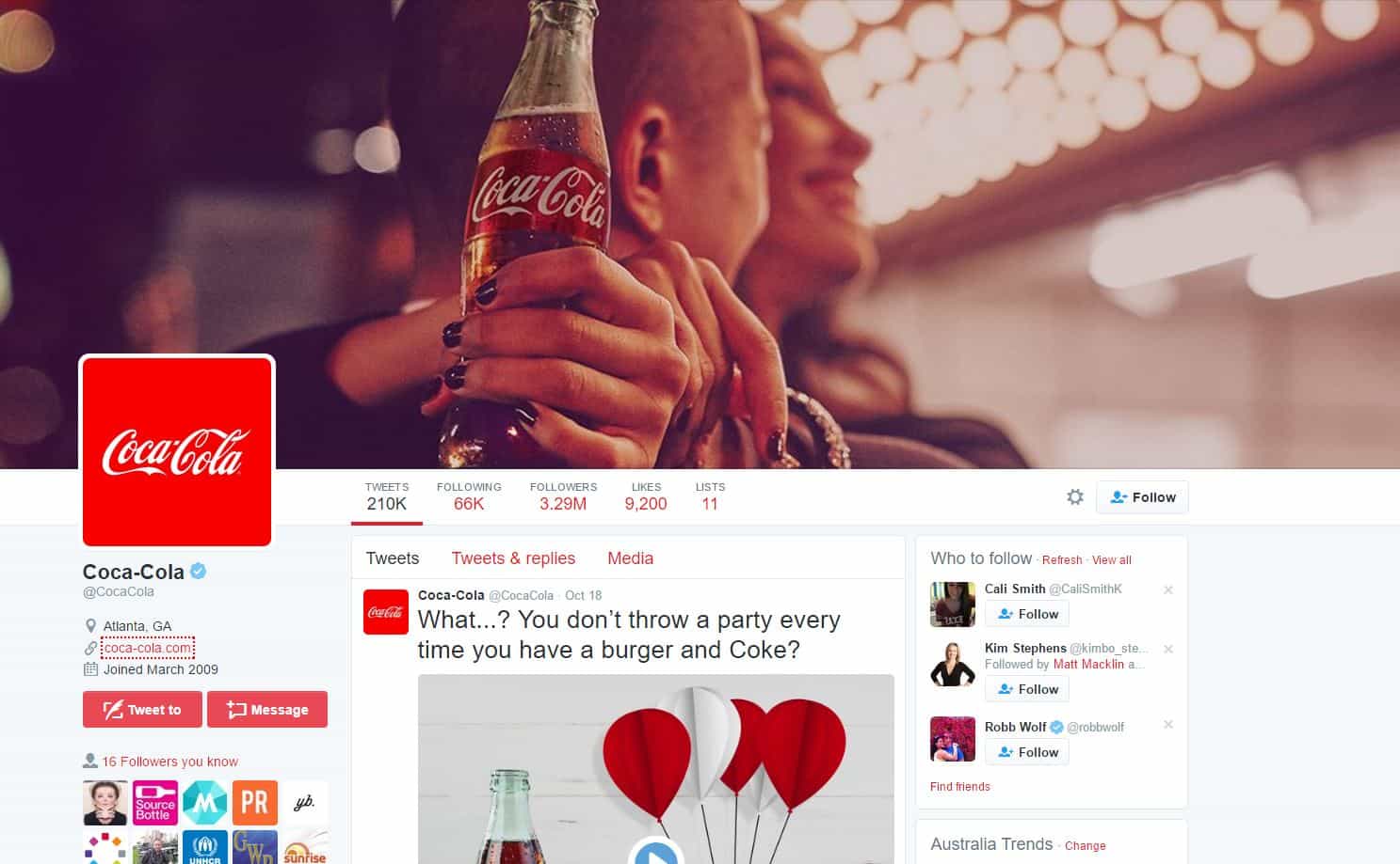 Coca-Cola verified Twitter profile page showing 3.29 million followers and a tweet about burgers and Coke