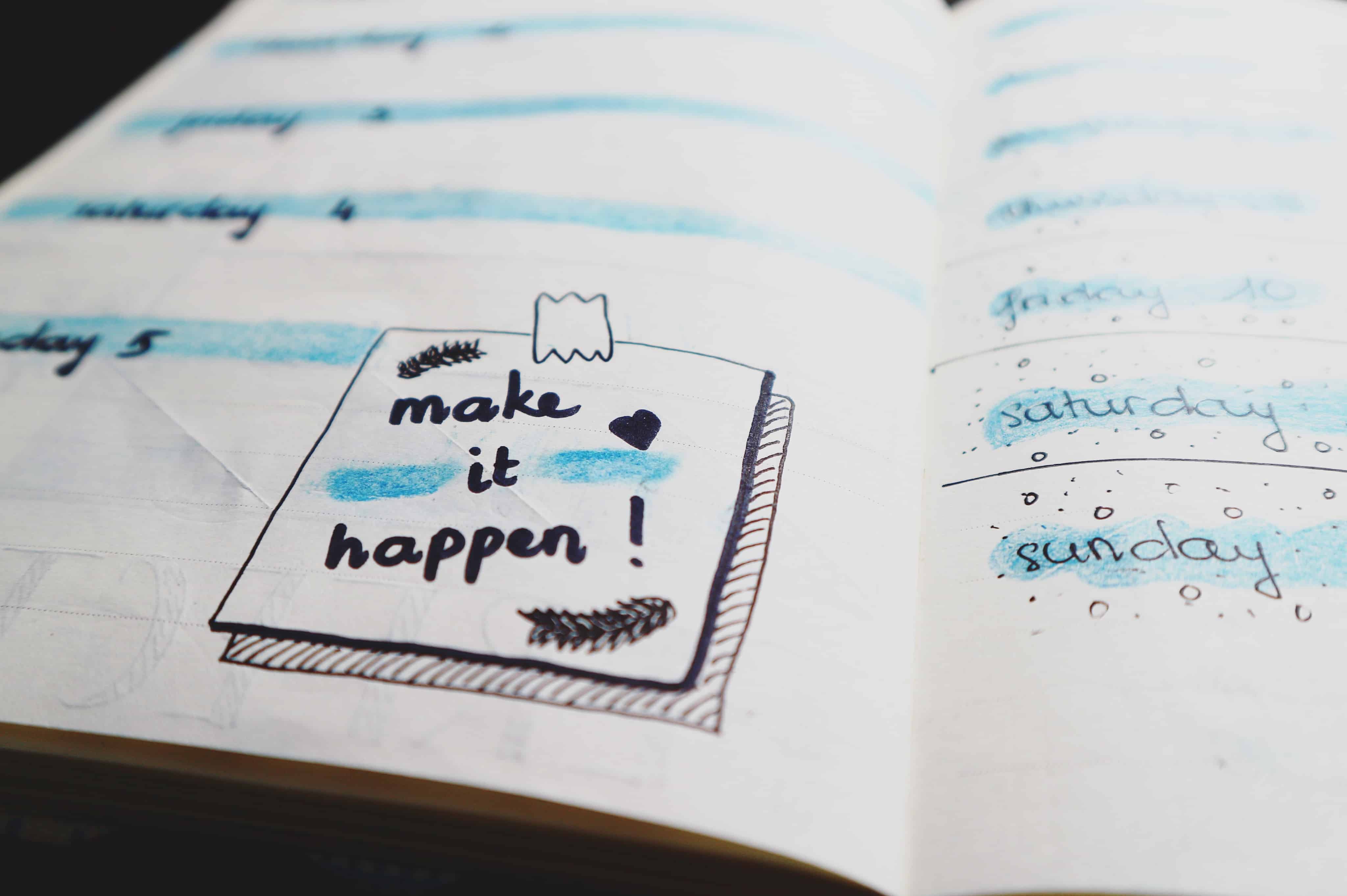 Open weekly planner notebook with a make it happen sticky note, illustrating productivity and time management tips