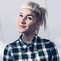 Headshot of Lauren Wiseman, digital marketing contributor smiling in a plaid shirt