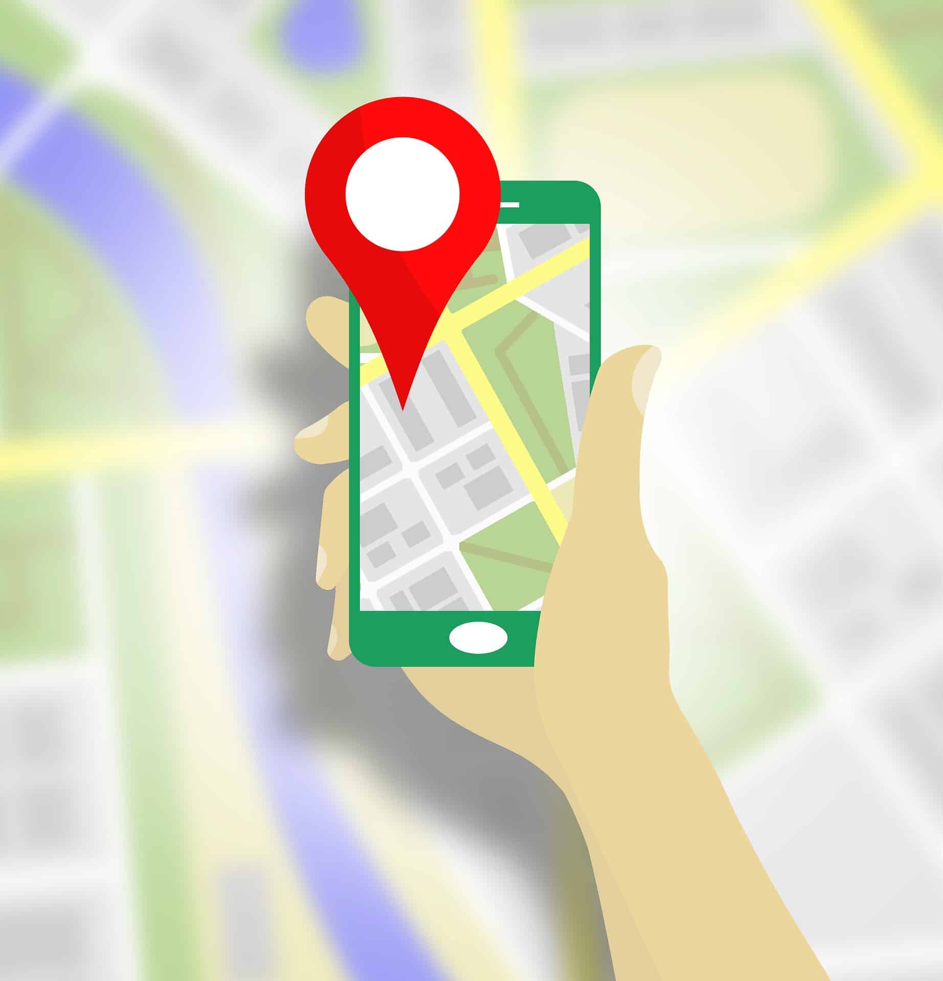 Hand holding a smartphone displaying a map with a red location pin, blurred street map in the background